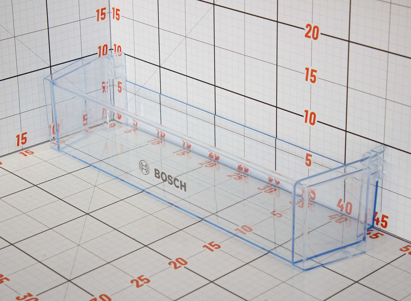 Clear plastic container with Bosch logo on a grid background